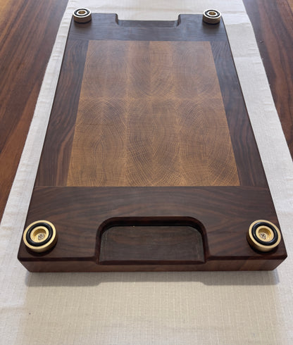 Unique endgrain walnut and white oak cutting board with elegant metal golden feet.