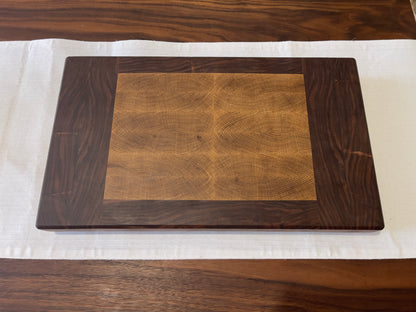 Unique endgrain walnut and white oak cutting board with elegant metal golden feet.