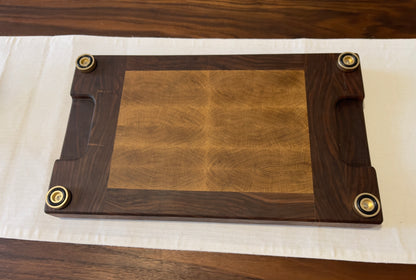 Unique endgrain walnut and white oak cutting board with elegant metal golden feet.