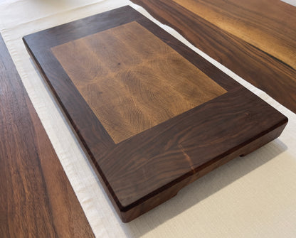 Unique endgrain walnut and white oak cutting board with elegant metal golden feet.