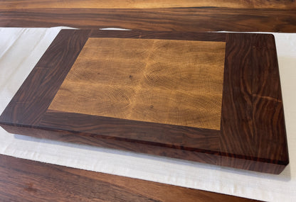 Unique endgrain walnut and white oak cutting board with elegant metal golden feet.