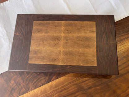 Unique endgrain walnut and white oak cutting board with elegant metal golden feet.